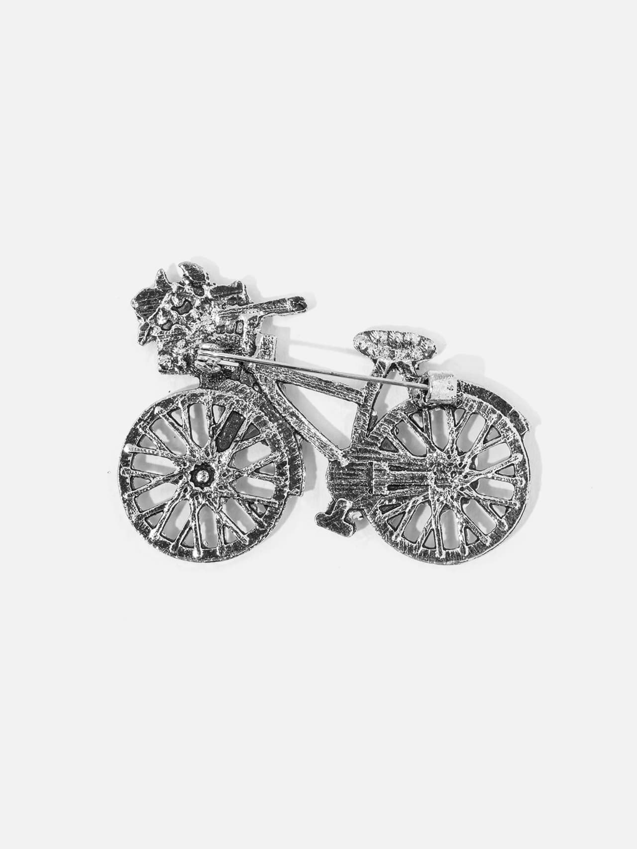 Färgglad brosch i form av en cykel baksida