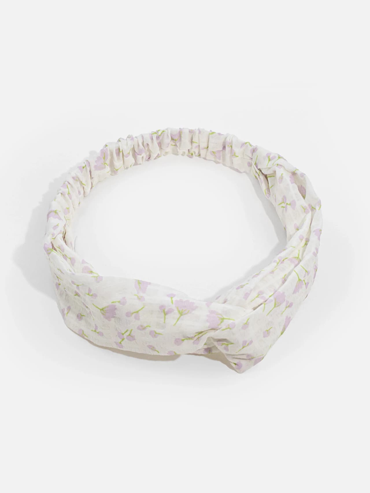 Knutat hårband i crèmevit med lila blommor och gröna stjälkar