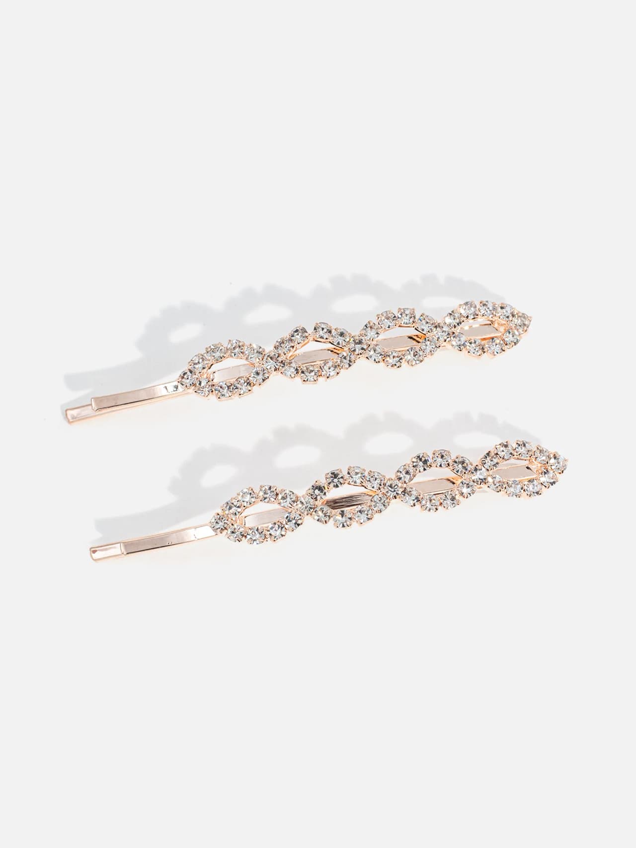Två roséguldsfärgade hårnålar med klara strassdetaljer, set i 2‑pack