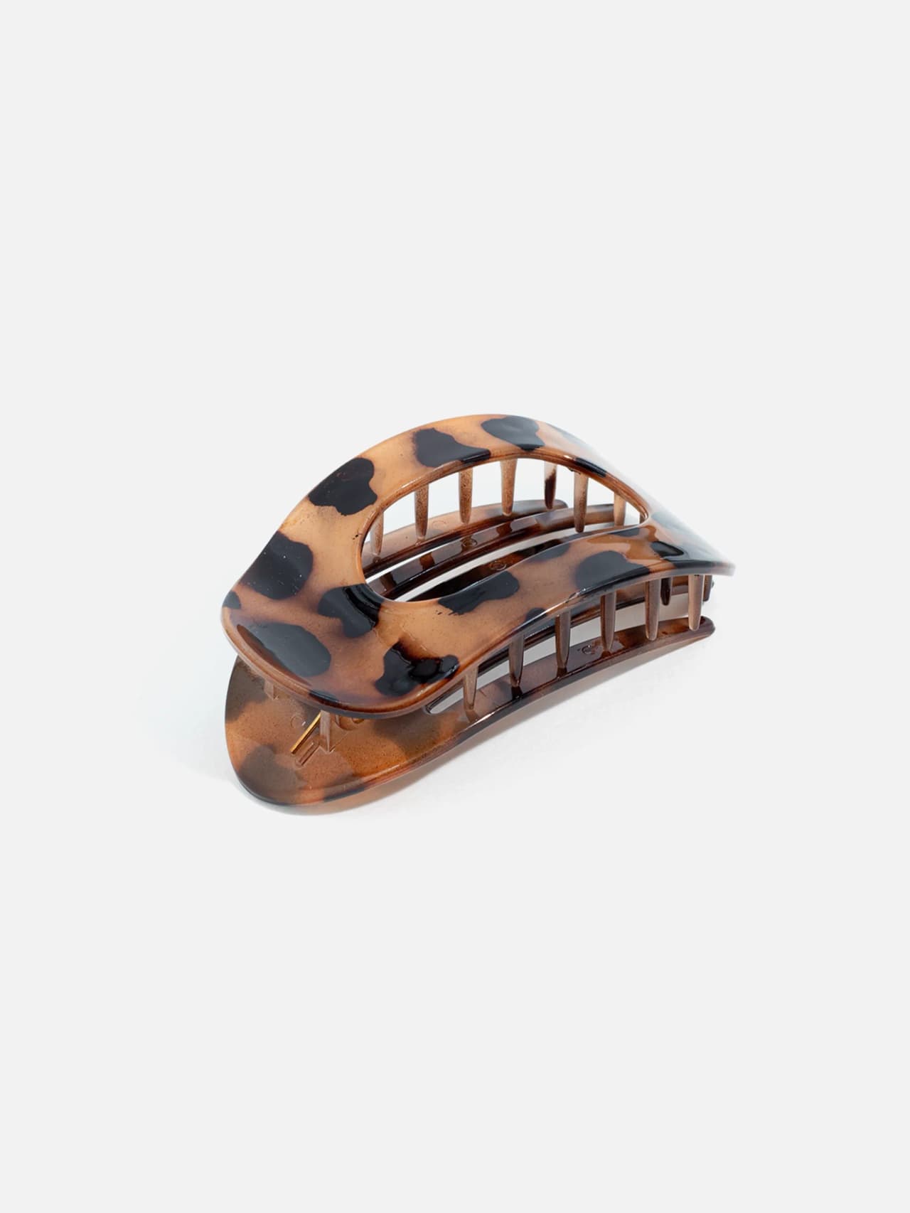 Bakre vy av oval hårklämma med brunt leopardmönster
