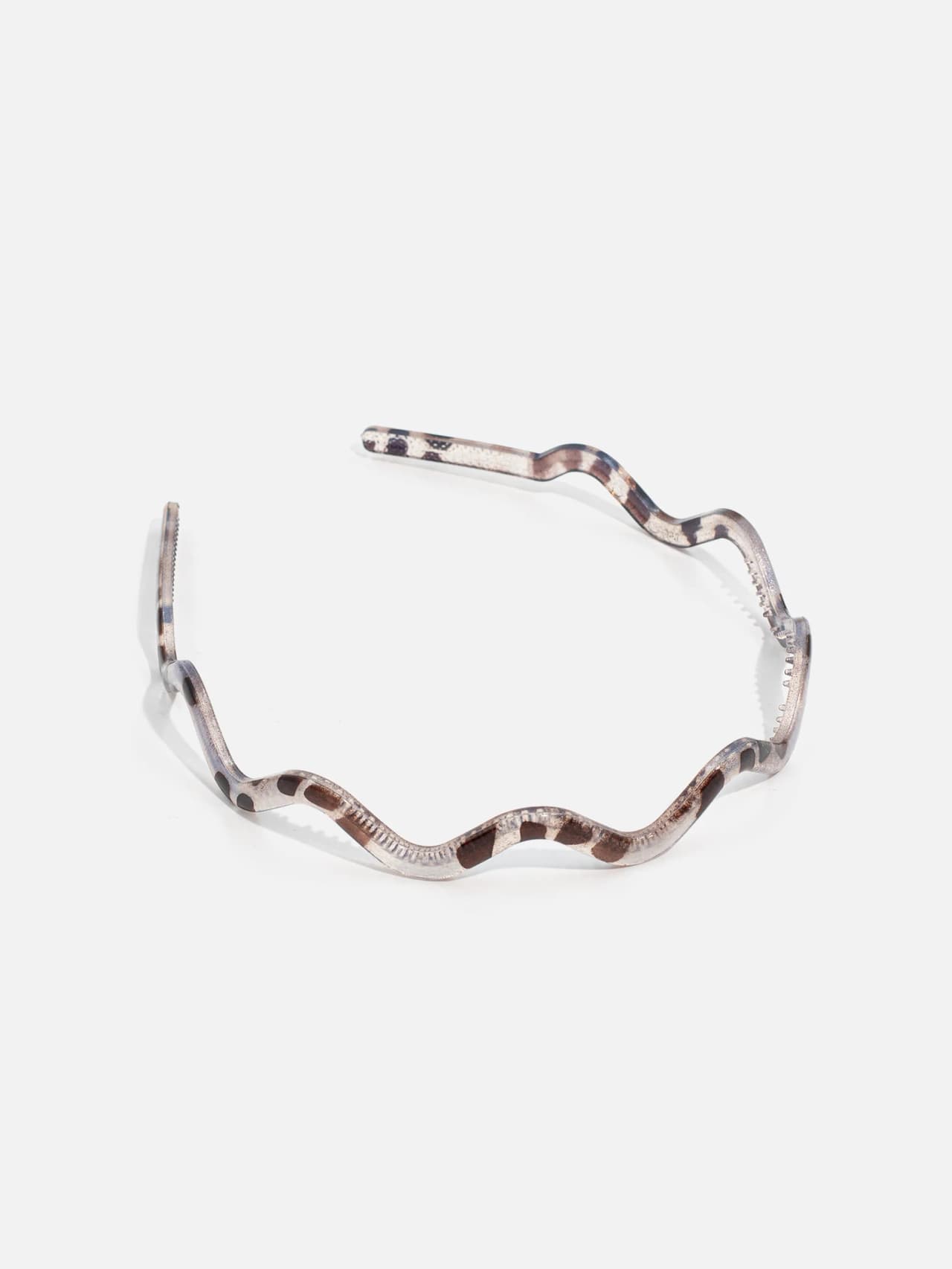 Champagnefärgat vågigt diadem med ljus transparent finish och greppdetaljer