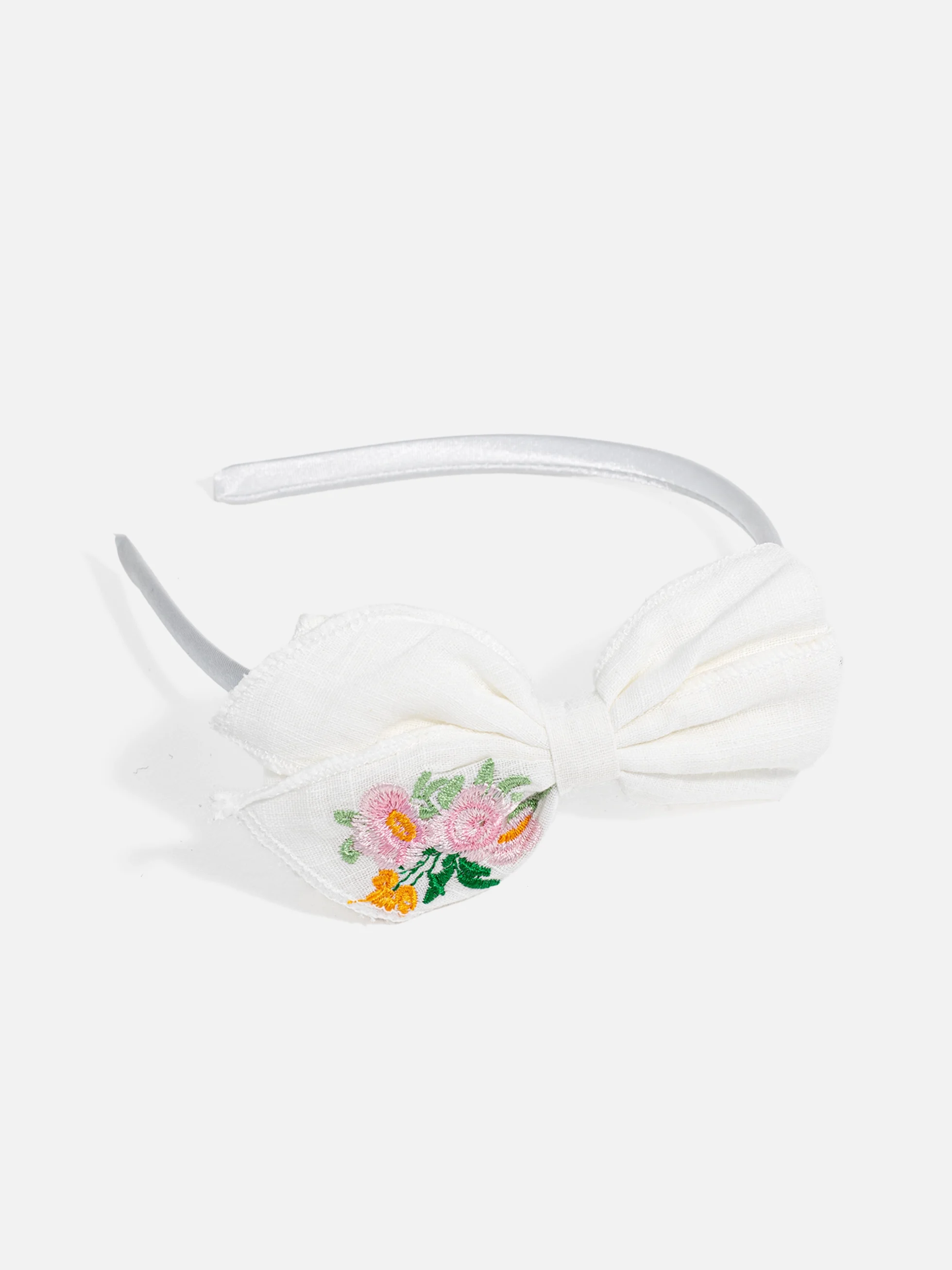 Sött barn diadem med fluga i elegant design.