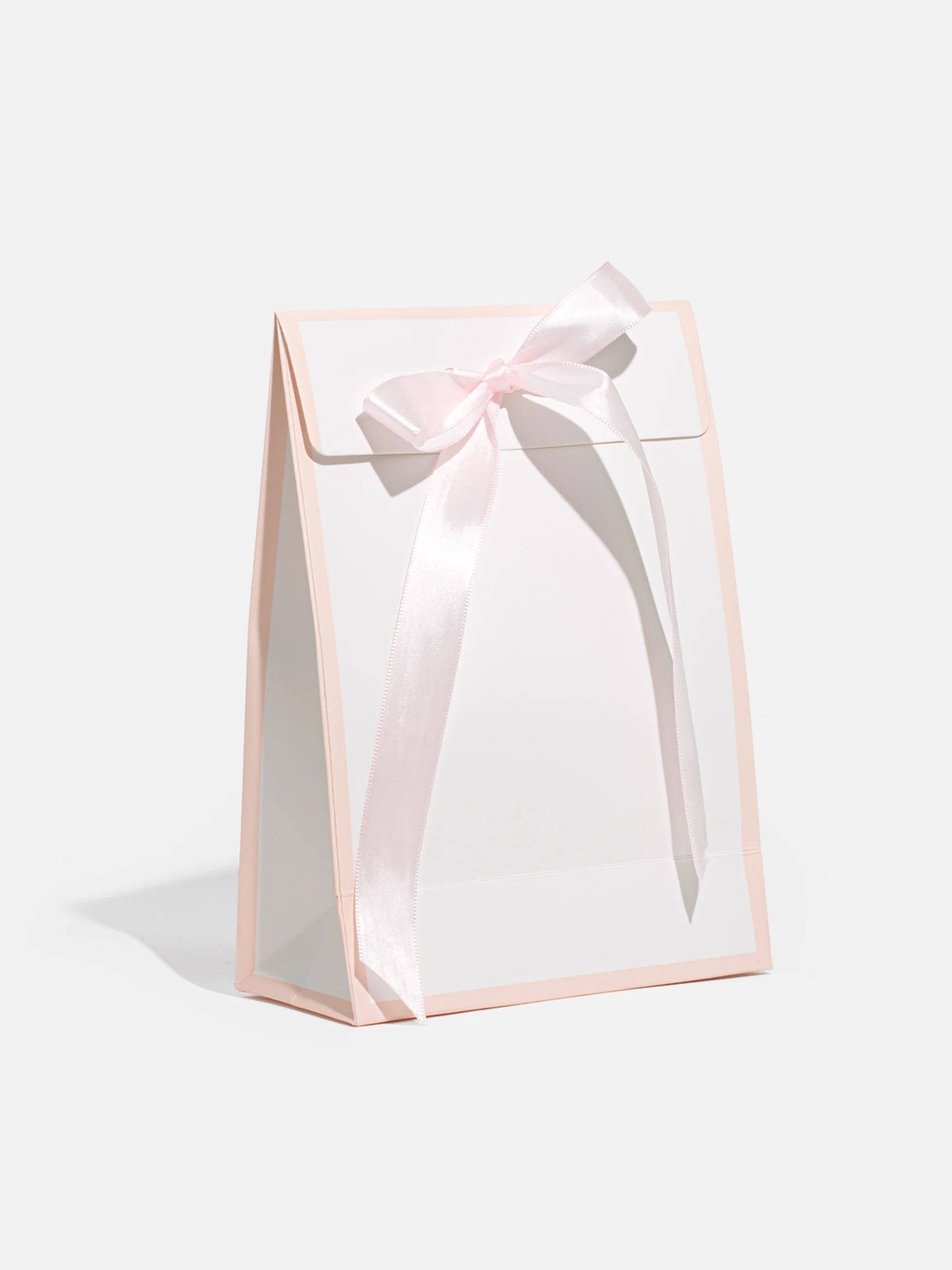 Rosa presentask med en matchande rosett, perfekt för små gåvor som smycken eller accessoarer.