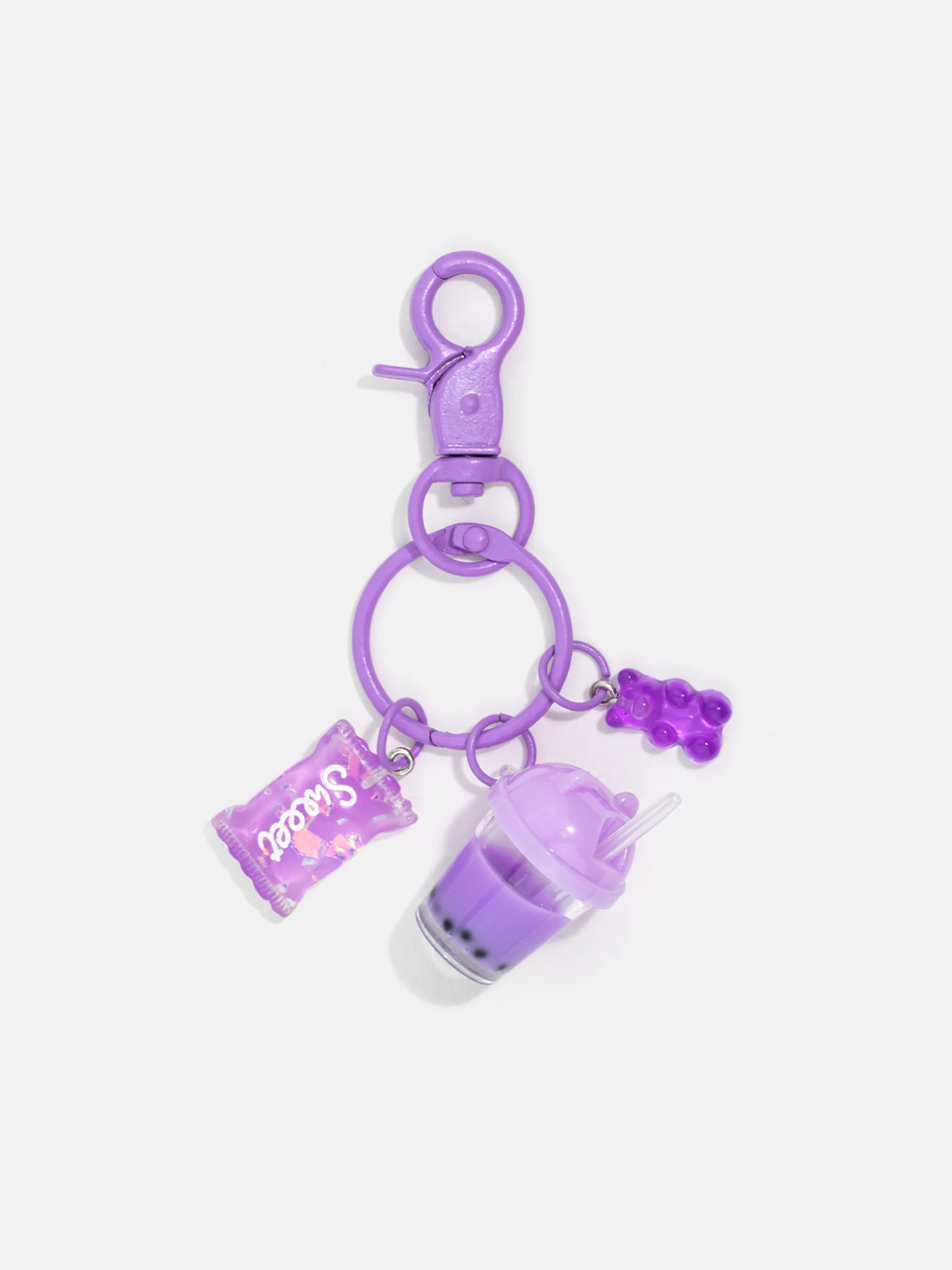 Söt lila nyckelring med charmiga detaljer som bubbelte och godis – en trendig accessoar.